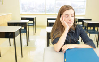 Teen high school student sleepy in school